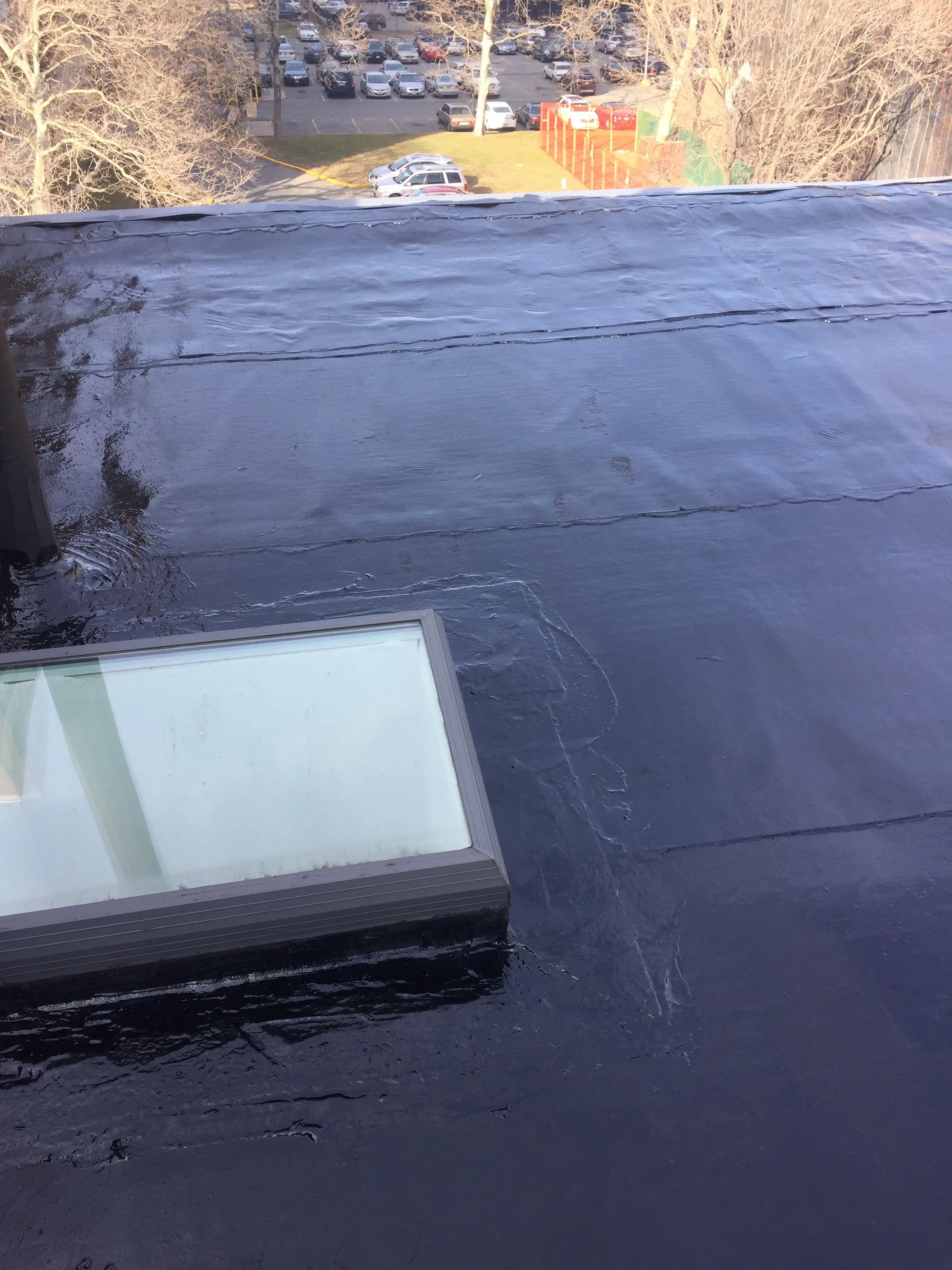 Flat roof coating in progress